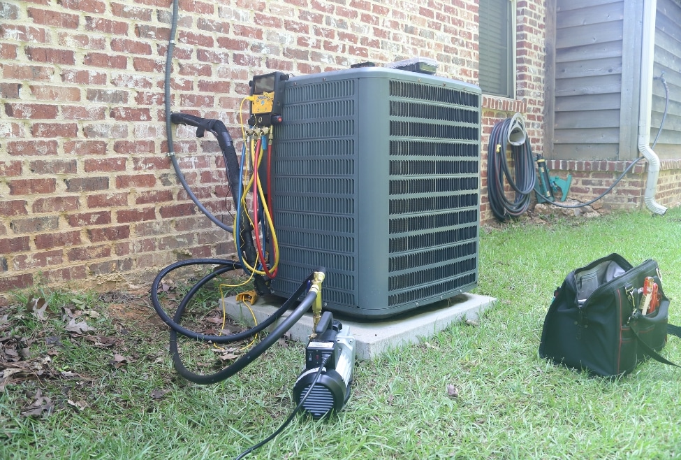 Professional technician performing maintenance and repair on an air conditioner unit surrounded by tools, representing quality AC repair services for customers searching for reliable HVAC companies near Lancaster, Palmdale, and Rosamond, CA. Contact Arctic Air today for 5-star HVAC services! Keywords: AC repair near me, HVAC maintenance, Air conditioner service, HVAC technician, Air conditioning repair, HVAC tools, AC maintenance, HVAC repair company, HVAC service provider, Air conditioning technician, AC Repair Palmdale, AC Repair Lancaster, AC Repair Quartz Hill, AC Repair Rosamond, AC Repair Acton, AC Repair Tehachapi, AC Repair Littlerock, AC Repair Mojave.