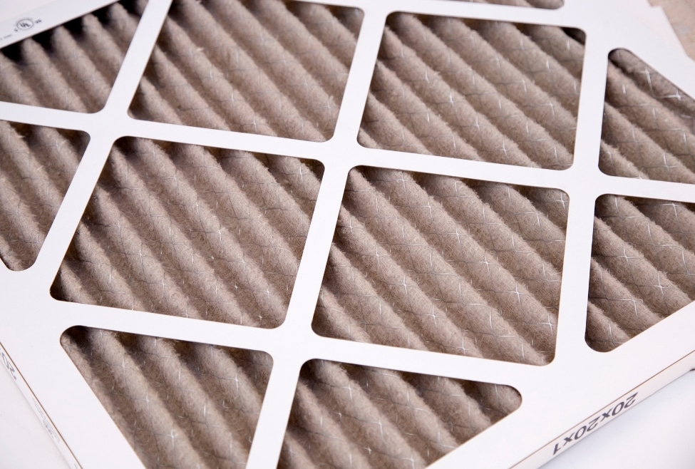 A close-up view of a dirty HVAC air filter, highlighting the importance of regular AC filter replacement for improved air quality and energy efficiency. This image represents the HVAC maintenance services provided by Arctic Air in Lancaster and Palmdale, CA, ensuring optimal performance of air conditioning systems. dirty air filter, HVAC maintenance, AC filter replacement, air quality, Lancaster CA, Palmdale CA, HVAC services, air conditioning repair, energy efficiency, airflow improvement, residential HVAC, commercial HVAC, Arctic Air AV, air conditioning services, HVAC repair, HVAC installation, clean air filter, HVAC efficiency, Southern California HVAC, cooling system maintenance.